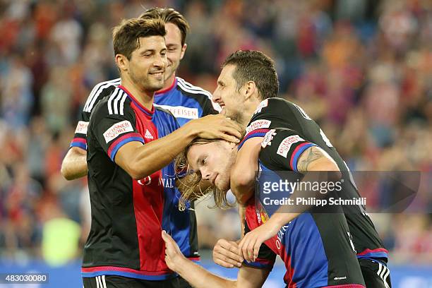 Birkir Bjarnason of FC Basel celebrates with his teammates after scoring his team's first goal during the UEFA Champions League third qualifying...