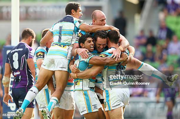 Titans players celebrate a try by Mark Minichiello during the round five NRL match between the Melbourne Storm and the Gold Coast Titans at AAMI Park...