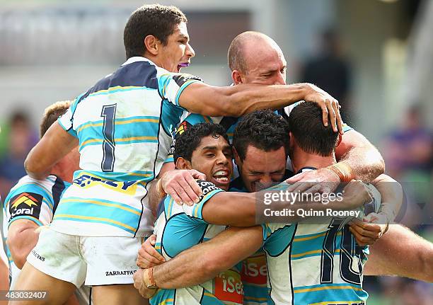 Titans players celebrate a try by Mark Minichiello during the round five NRL match between the Melbourne Storm and the Gold Coast Titans at AAMI Park...