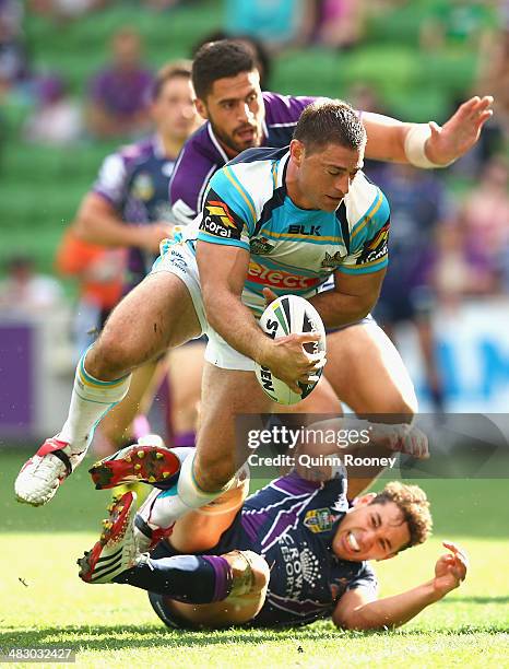 Mark Minichiello of the Titans scores a try over the top of Billy Slater of the Storm during the round five NRL match between the Melbourne Storm and...