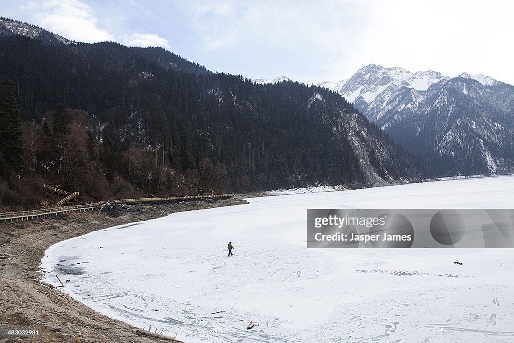 Man walking across frozen lake in China