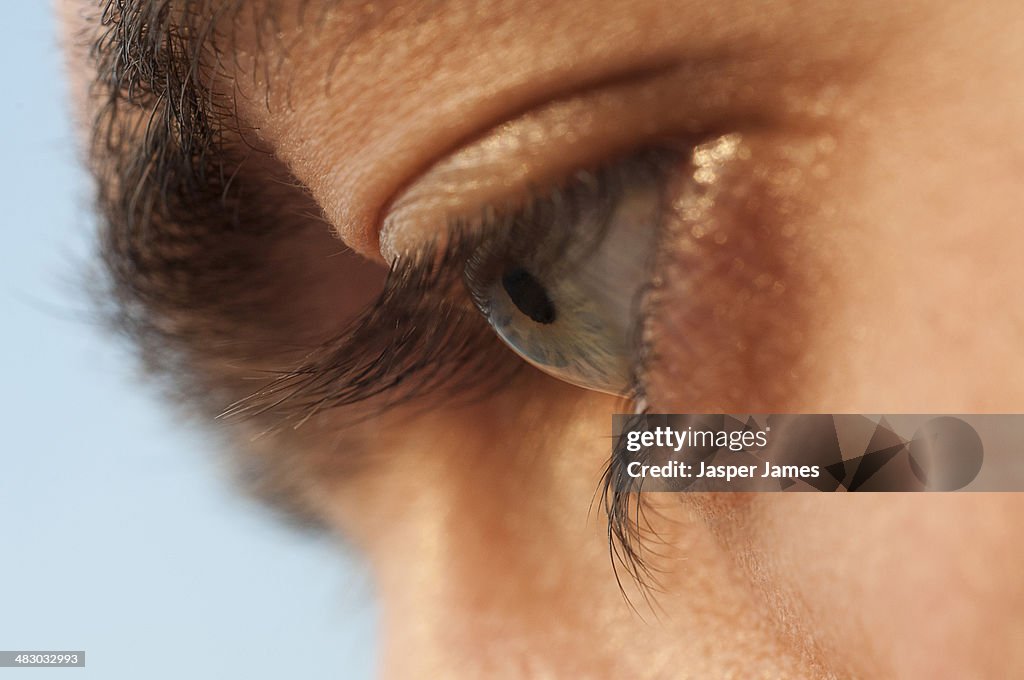 Close up of a mans eye looking down