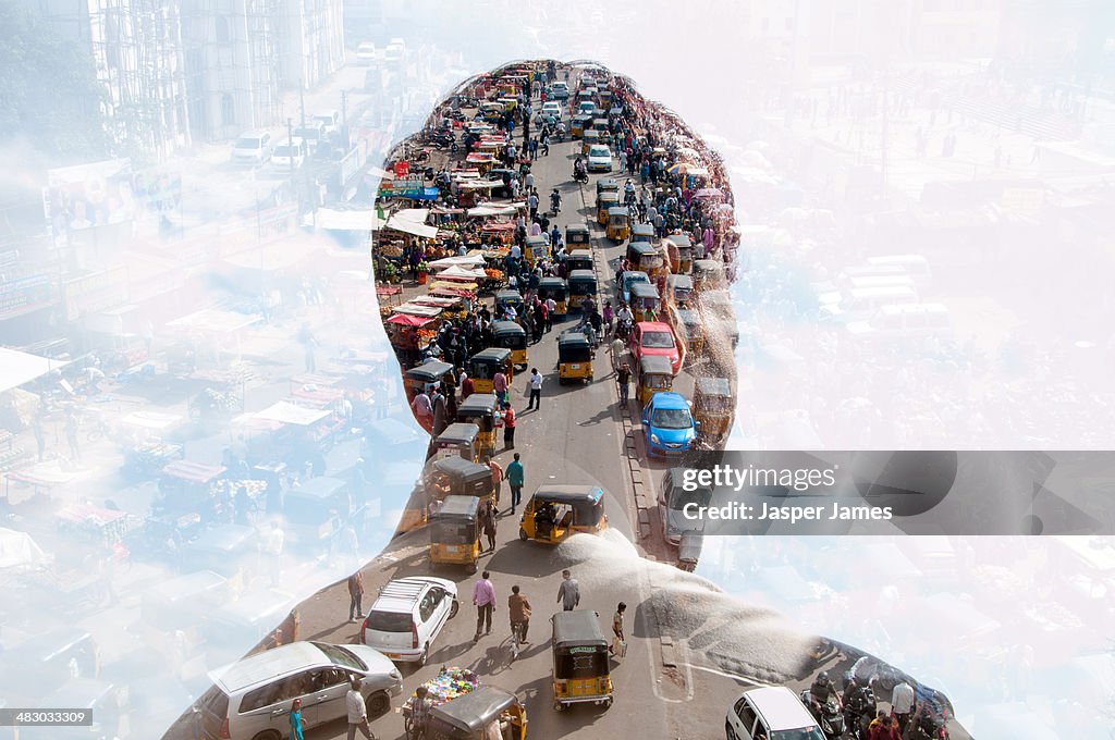 Double exposure of man and Indian cityscape