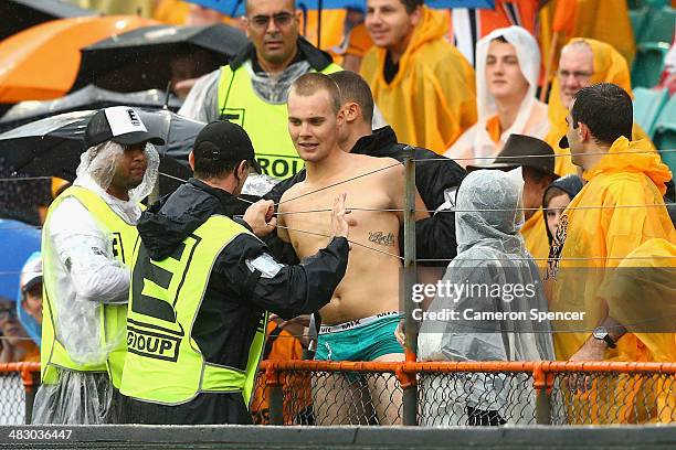 Streaker is arrested after disrupting play during the round five NRL match between the Wests Tigers and the Manly-Warringah Sea Eagles at Leichhardt...