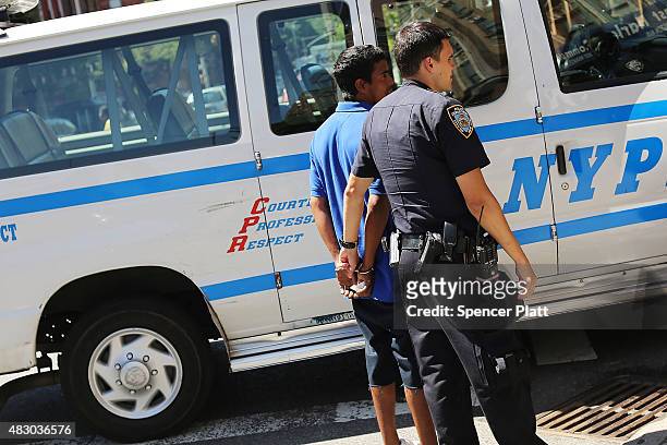 Police arrest a man in an area where people smoke K2 or "Spice", a synthetic marijuana drug, in East Harlem on August 5, 2015 in New York City. New...