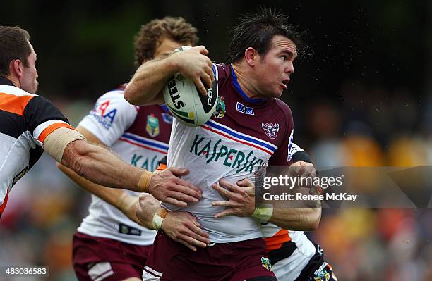 Jamie Lyon of Manly is tackled by the Tigers defence during the round five NRL match between the Wests Tigers and the Manly-Warringah Sea Eagles at...