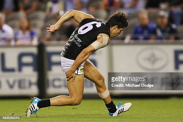 Angus Monfries of the Power injures his hamstring while running for the ball to an open goal during the round three AFL match between the North...