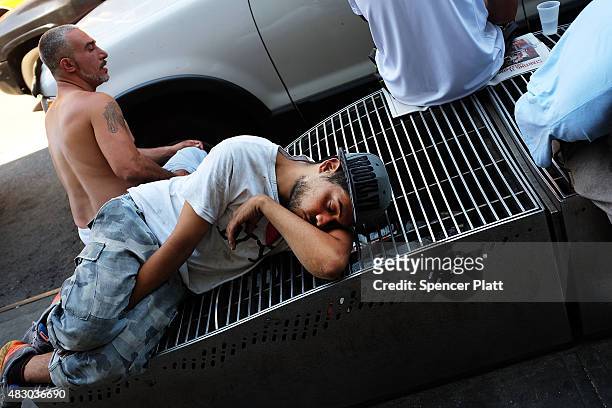 Men who are high on K2 or "Spice", a synthetic marijuana drug, sleep along a street in East Harlem on August 5, 2015 in New York City. New York,...