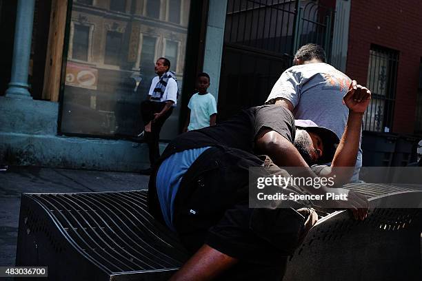 Men who are high on K2 or "Spice", a synthetic marijuana drug, sleep along a street in East Harlem on August 5, 2015 in New York City. New York,...