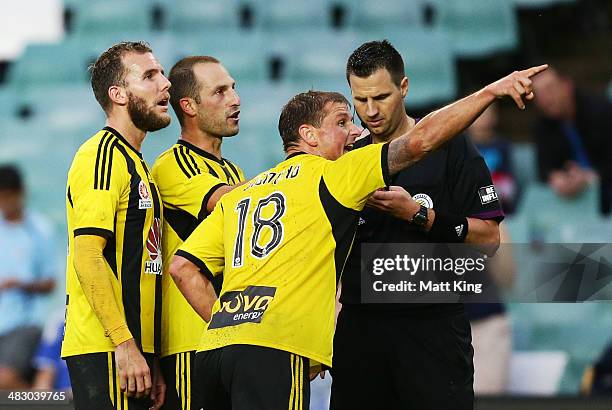 Jeremy Brockie, Andrew Durante and Ben Sigmund of the Phoenix point to the reply after the referee awarded a penalty kick to Sydney FC which led to...