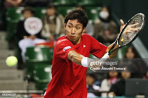 Yasutaka Uchiyama of Japan plays a backhand during his match against Lukas Rosol of the Czech Republic during day three of the Davis Cup World Group...