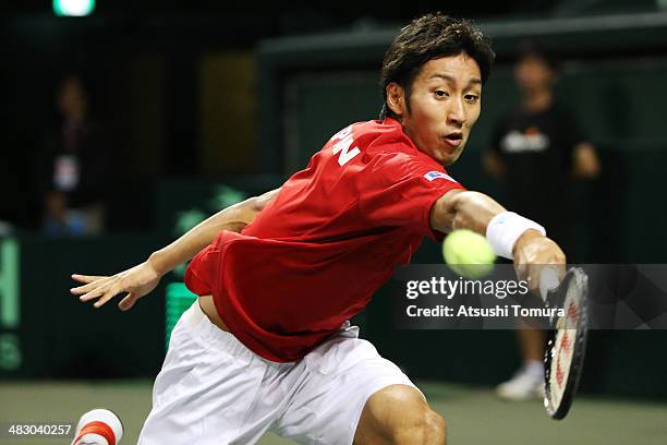 Yasutaka Uchiyama of Japan plays a backhand during his match against Lukas Rosol of the Czech Republic during day three of the Davis Cup World Group...