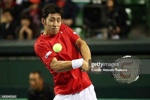 Yasutaka Uchiyama of Japan plays a backhand during his match against Lukas Rosol of the Czech Republic during day three of the Davis Cup World Group...