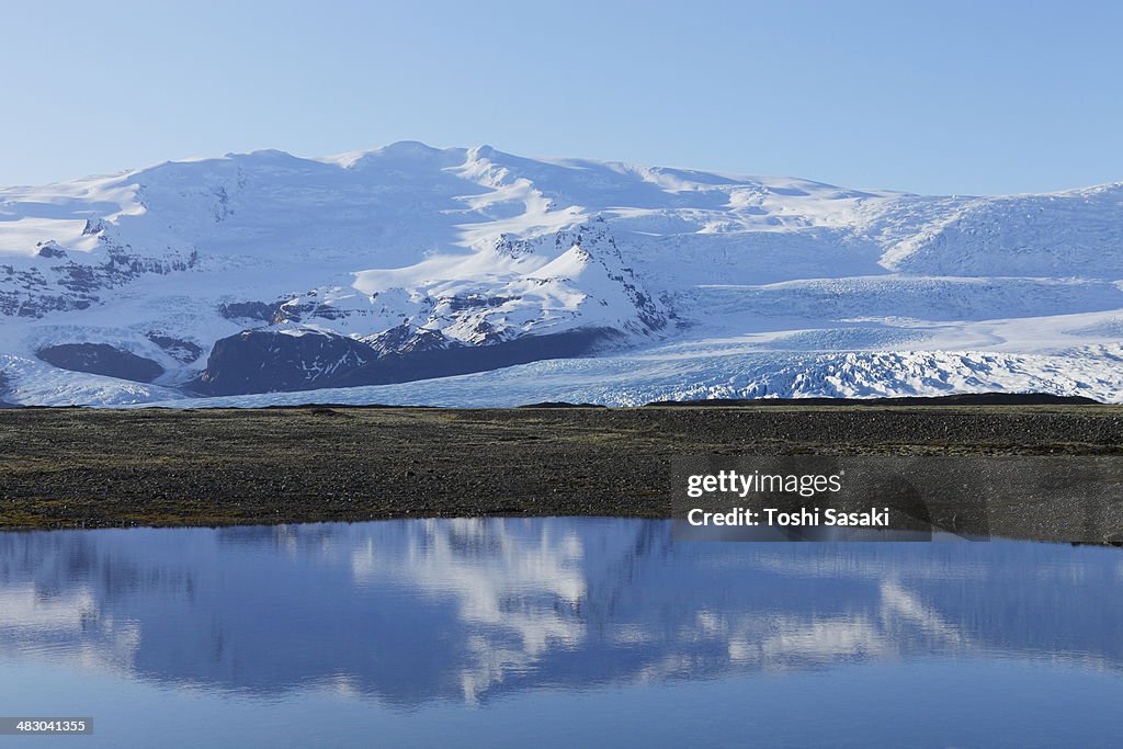 Fjallsjokull glacier are reflected to lagoon, Icel