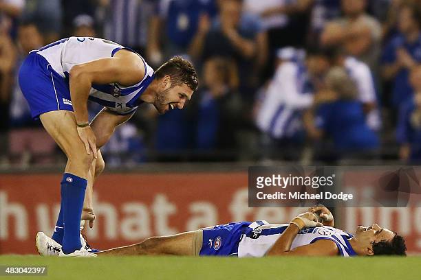 Aaron Black of the Kangaroos and Lindsay Thomas celebrate their win on the siren during the round three AFL match between the North Melbourne...