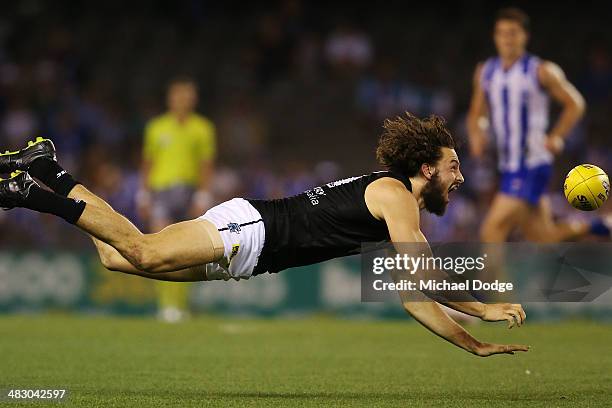 John Butcher of the Power handpasses the ball during the round three AFL match between the North Melbourne Kangaroos and the Port Adelaide Power at...