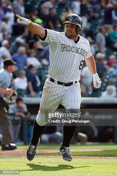 Michael McKenry of the Colorado Rockies celebrates as he rounds the bases on his game winning walk off two run home run off of Mayckol Guaipe of the...