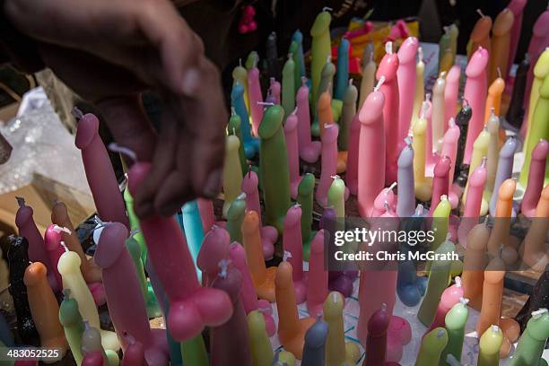 Man buys a phallic-shaped candle at the Wakamiya Hachimangu shrine during Kanamara Matsuri on April 6, 2014 in Kawasaki, Japan. The Kanamara Festival...