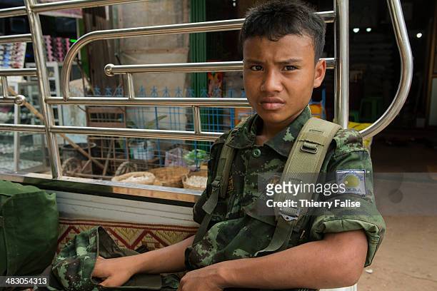 Young soldier from the Democratic Karen Buddhist army , an ethnic Karen armed group which have signed a cease-fire with the government, is sitting in...