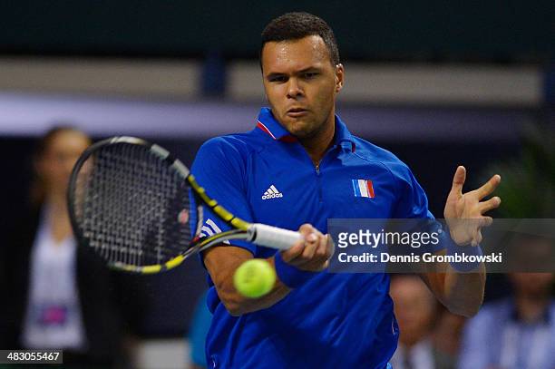 Jo-Wilfried Tsonga of France plays a forehand in his match against Tobias Kamke of Germany during day 3 of the Davis Cup Quarter Final match between...