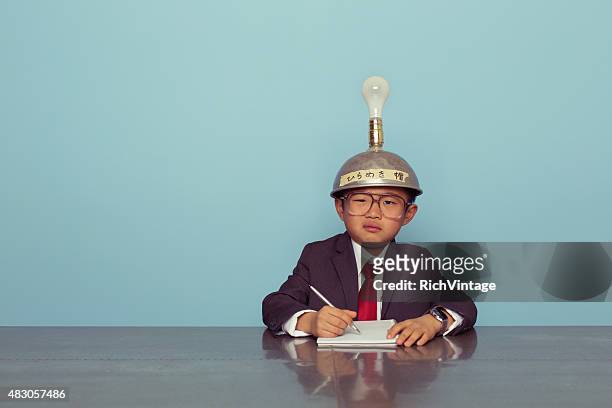 confused japanese business boy wearing thinking cap - electrical failure stock pictures, royalty-free photos & images