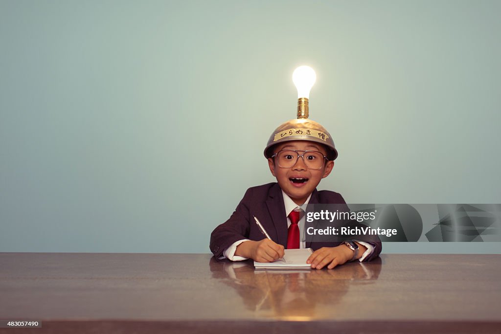 Surprised Japanese Business Boy Wearing Lit Up Thinking Cap
