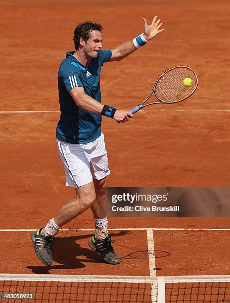 Andy Murray of Great Britain plays a backhand volley during his straight sets defeat in the fourth rubber by Fabio Fognini of Italy during day three...