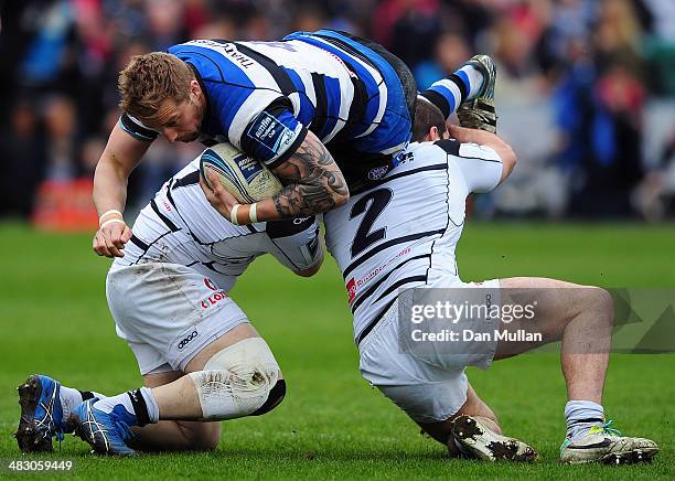 Dom Day of Bath is tackled by Damien Lavergne and Louis Acosta of Brive during the Amlin Challenge Cup quarter final match between Bath and Brive at...