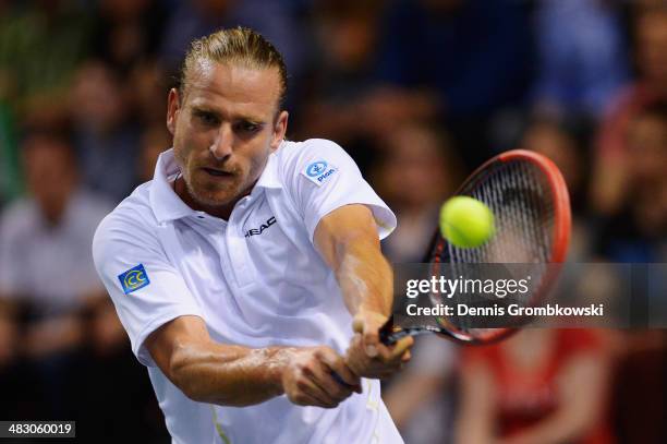 Peter Gojowczyk of Germany plays a backhand in his match against Gael Monfils of France during day 3 of the Davis Cup Quarter Final match between...