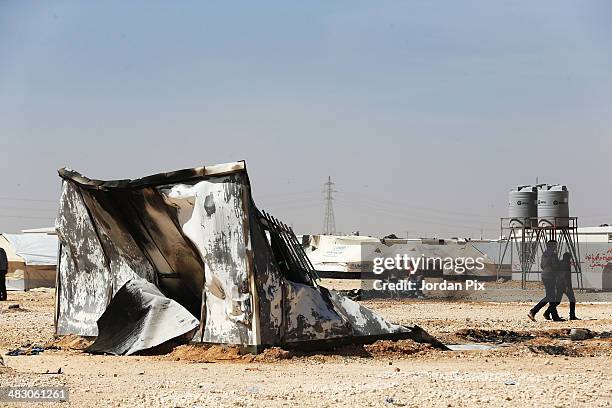 Syrian refugees survey the damage of the clashes that took place the previous evening between refugees and security forces in the Zaatari refugee...