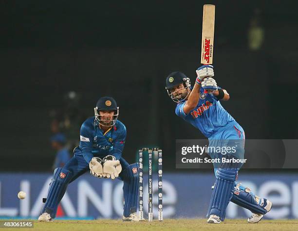 Virat Kohli of India bats as Kumar Sangakkara of Sri Lanka looks on during the Final of the ICC World Twenty20 Bangladesh 2014 between India and Sri...