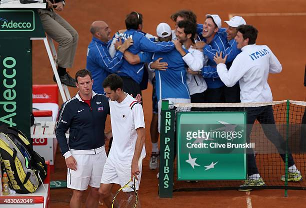 James Ward of Great Britain is consoled by his team captain Leon Smith after losing the fifth and decisive rubber to Andreas Seppi of Italy during...