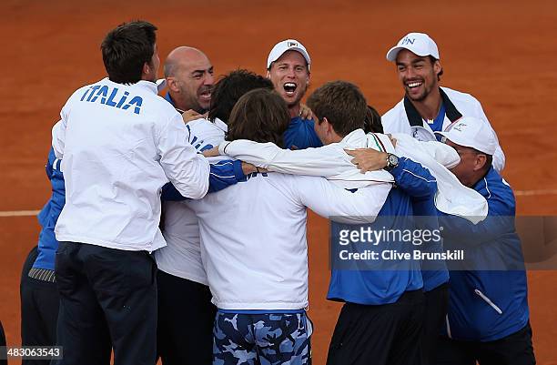 Jubilant Italian team celebrate advancing to the semi-finals after James Ward of Great Britain lost the fifth and decisive rubber to Andreas Seppi of...