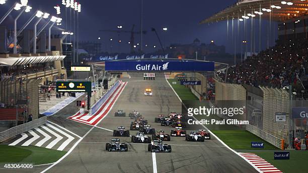 Lewis Hamilton of Great Britain and Mercedes GP and team mate Nico Rosberg of Germany and Mercedes GP lead the field towards the first corner at the...