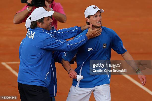 Andreas Seppi of Italy is congratulated by team members after winning the fifth and decisive rubber against James Ward of Great Britain during day...