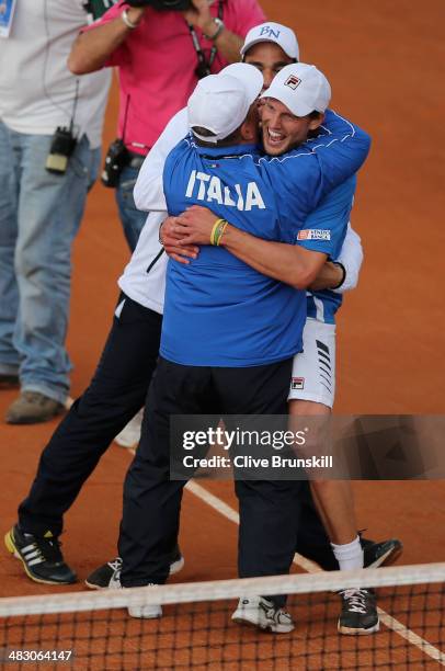 Andreas Seppi of Italy is congratulated by team members after winning the fifth and decisive rubber against James Ward of Great Britain during day...