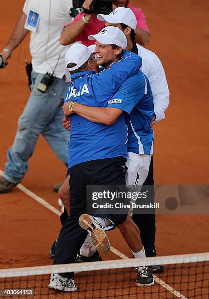 Andreas Seppi of Italy is congratulated by team members after winning the fifth and decisive rubber against James Ward of Great Britain during day...