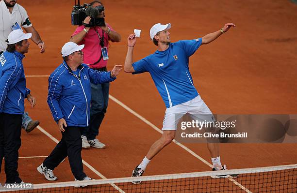 Andreas Seppi of Italy is throws his wristband to the crowd after winning the fifth and decisive rubber against James Ward of Great Britain during...