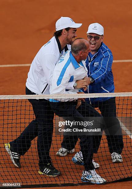 Italian team captain Corrado Barazzutti is grabbed by Fabio Fognini after Andreas Seppi of Italy has won the fifth and decisive rubber against James...