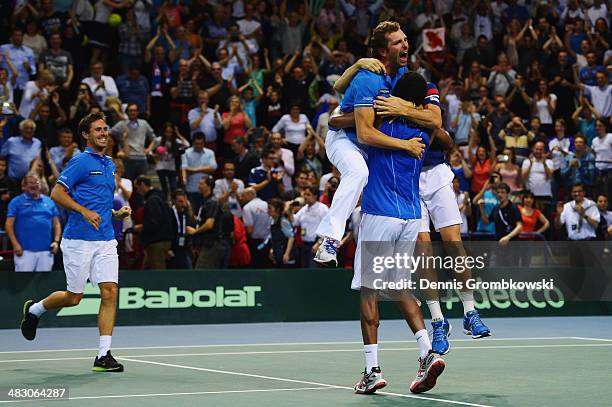 Gael Monfils of France celebrates with team mates after winning his match against Peter Gojowczyk of Germany during day 3 of the Davis Cup Quarter...