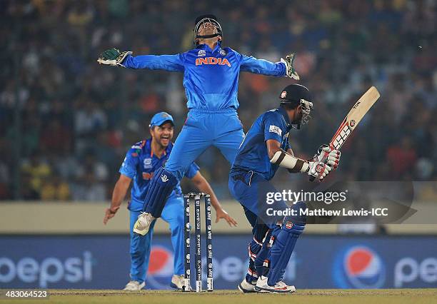 Mahendra Singh Dhoni of India celebrates catching Lahiru Thirimanne of Sri Lanka, off the bowling of Amit Mishra during the ICC World Twenty20...