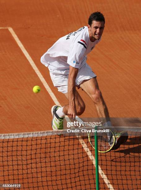 James Ward of Great Britain runs to play a backhand volley during the fifth and decisive rubber against Andreas Seppi of Italy during day three of...