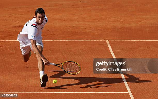 James Ward of Great Britain runs to play a backhand volley during the fifth and decisive rubber against Andreas Seppi of Italy during day three of...