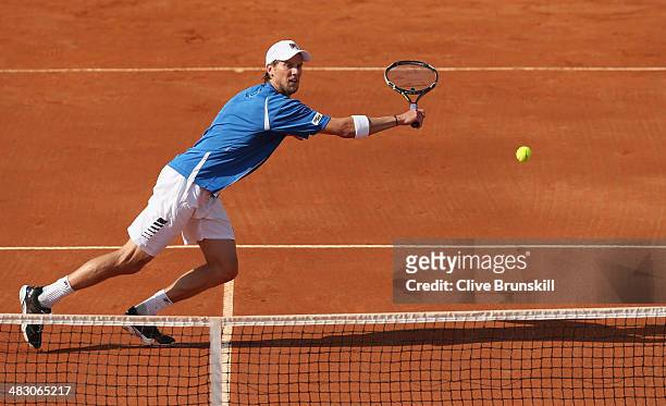 Andreas Seppi of Italy runs to play a backhand volley during the fifth and decisive rubber against James Ward of Great Britain during day three of...