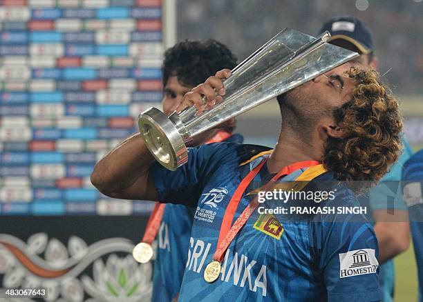 Sri Lanka captain Lasith Malinga kisses the trophy as he celebrates with teammates after Sri Lanka won the ICC World Twenty20 cricket tournament...