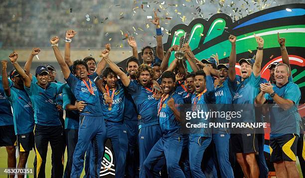 Sri Lanka players celebrate as they pose with the ICC World Twenty20 cricket tournament champions trophy after winning the final match against India...