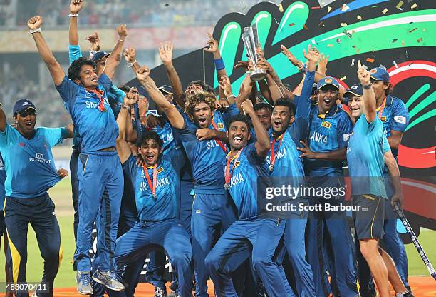 Lasith Malinga of Sri Lanka and his team celebrate with the trophy on the podium after winning the Final of the ICC World Twenty20 Bangladesh 2014...