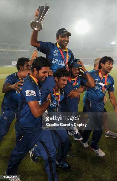 Mahela Jayawardena of Sri Lanka is chaired from the field by Sachithra Senanayake and Dinesh Chandimal after winning the ICC World Twenty20...