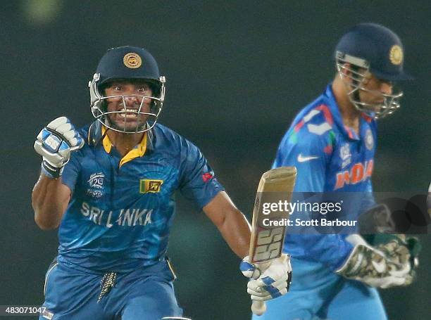 Kumar Sangakkara of Sri Lanka celebrates in the final over as MS Dhoni of India looks on during the Final of the ICC World Twenty20 Bangladesh 2014...