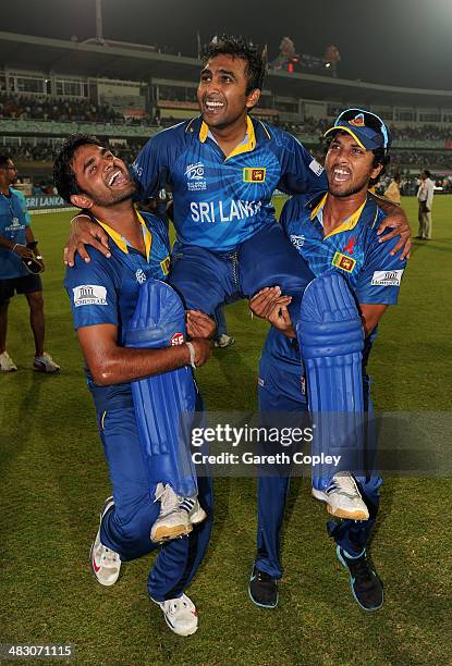 Mahela Jayawardena of Sri Lanka is chaired from the field by Lahiru Thirimanne and Dinesh Chandimal after winning the ICC World Twenty20 Bangladesh...